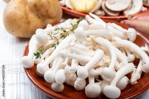 Ingredients for dinner dish with potato and mushrooms with onion. White shimeji edible mushrooms native to East Asia, buna-shimeji is widely cultivated