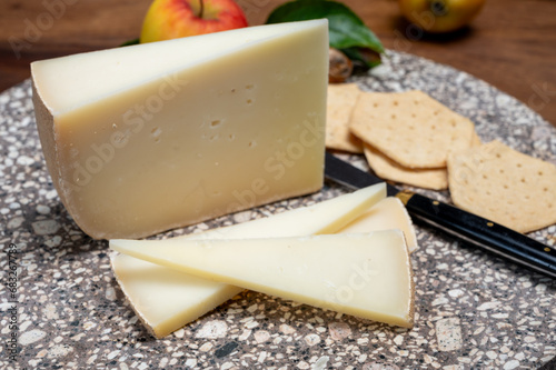 Piece of tasty Ossau-Iraty or Esquirrou sheep cheese produced in south-western France, Northern Basque Country photo