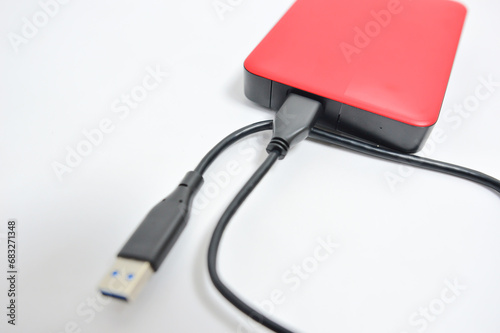 External hard disk drive with USB cable isolated on white background. Memory drive.