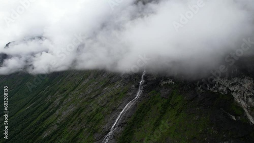 Cinematic aerial view of waterfall flowing glacier melt down in the Fjords of Norway photo