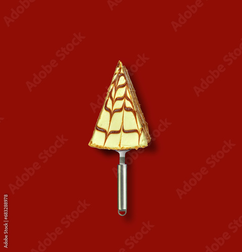 Merry Christmas and Happy New Year concept. Pastry slices and spoons created a Christmas tree. Restaurant and fast food concept.  © Artstory