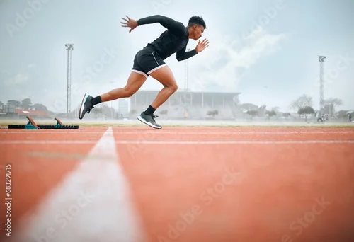 Obraz Man, athlete and ready for race on track with practice, training or exercise for competition. Black person, runner and fast with dedication, determination and passion on face with speed for sport