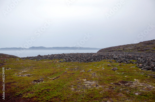 A cluster of stone boulders on the shores of the Barents Sea. Rural settlement Teriberka. Kola district, Murmansk region. Russia photo