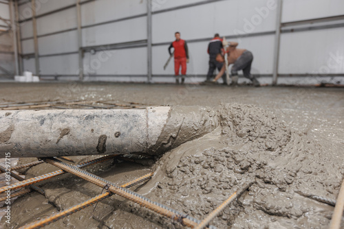 Concrete concreting floors of buildings in construction site. Concept pouring cement to iron structure
