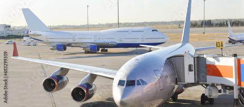 IL-96-300 aircraft boarding passengers. In an Aeroport. Boeing 747 in the background