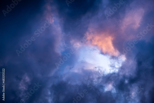 Blue hole in the dark cloudy sky. Storm Clouds. Evening sunset. Rainy and stormy weather. Art wallpaper. Natural landscape. Beauty in nature. After thunderstorm. The hope concept. High quality photo