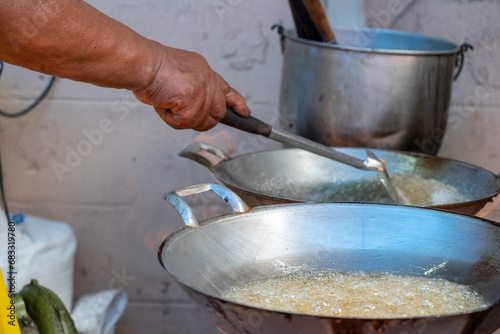 Chef Simmering Peanut in Syrup to Make Smashed Peanut Candy in the Vegetarian Festival