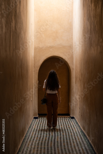 Obraz na płótnie Stunning view of a girl visiting the Bahia Palace during a sunny day. The Bahia Palace in Marrakech is an impressive example of Moroccan architecture and design. w salonie