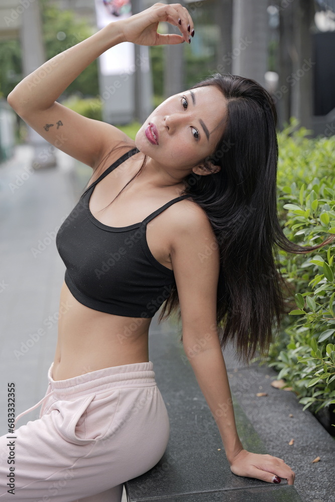 Young Asian woman wears leisure pants and tops outdoor Young Asian woman wears leisure pants and tops outdoor
