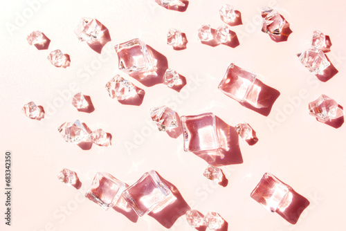Ice cubes on a pink background. View from above