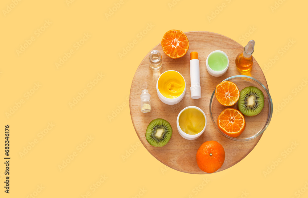 Flat lay of vitamin moisturizing natural cosmetics with fruit extracts on yellow and wooden background. Advertising of new cosmetic products. Anti-aging skin care concept. Top view, copy space, mockup Flat lay of vitamin moisturizing natural cosmetics with fruit extracts on yellow and wooden background. Advertising of new cosmetic products. Anti-aging skin care concept. Top view, copy space, mockup