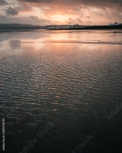 A stunning windy beach sunset at low tide