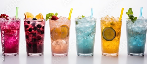 Multicolored summer drinks with ice and straw on white background Top view