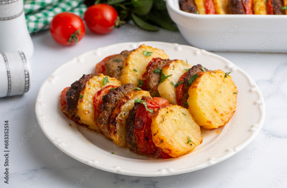 Traditional Turkish food; baked potatoes and meatballs. Turkish name; kofteli patates dizmesi, patates dizme