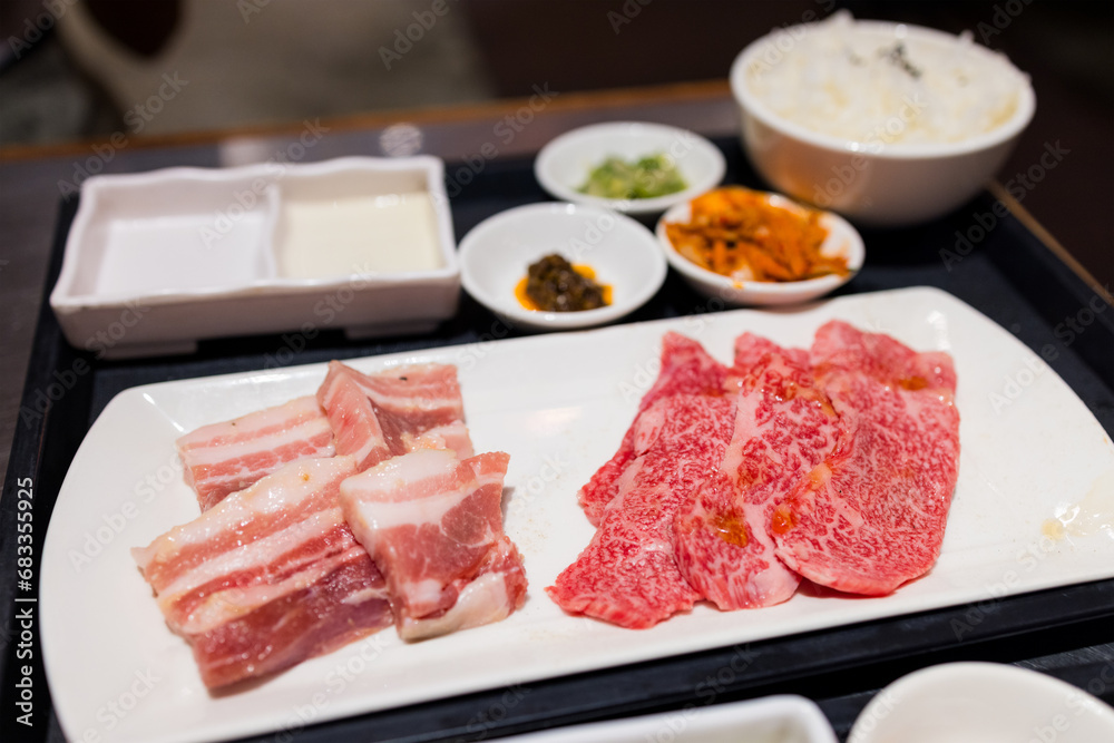 Slice of the fresh raw beef in the yakiniku restaurant