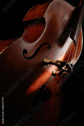 Beautiful classic double bass. Acoustic contrabass . Wooden musical string instrument. Wooden Double bass bridge and strings. Close up. Music concept. Selective focus photo
