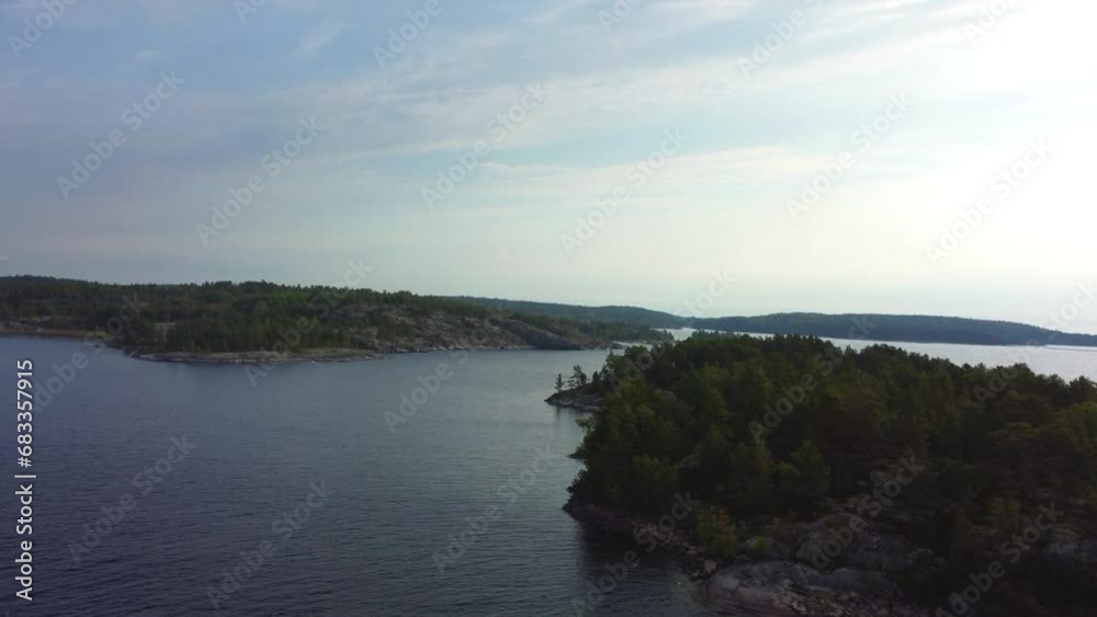 Russia, Lake Ladoga, Koyonsaari. View of the coast of the island in a cold lake. Beautiful nature of the Republic of Karelia. Panoramic view from the height of the Ladoga skerry islands. 4K Russia, Lake Ladoga, Koyonsaari. View of the coast of the island in a cold lake. Beautiful nature of the Republic of Karelia. Panoramic view from the height of the Ladoga skerry islands. 4K