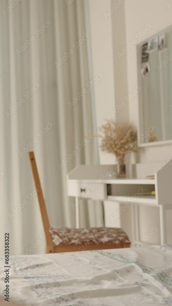Vertical video. Bedroom with a bright and beautiful interior, a man and a woman on the bed. While she works or studies with a laptop on her lap, he caresses her knee. View from the man's perspective, Vertical video. Bedroom with a bright and beautiful interior, a man and a woman on the bed. While she works or studies with a laptop on her lap, he caresses her knee. View from the man's perspective,