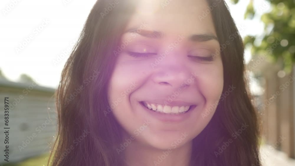 Close up of smiling young attractive brunette with swarthy skin, snow white teeth, green eyes, standing outdoors on sunny day. Blurred background. High quality 4k footage Close up of smiling young attractive brunette with swarthy skin, snow white teeth, green eyes, standing outdoors on sunny day. Blurred background. High quality 4k footage