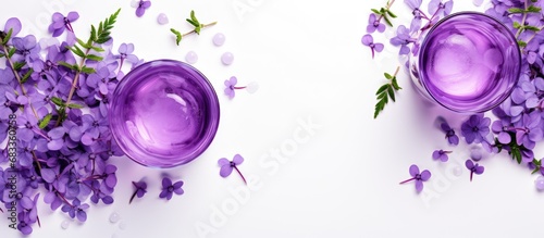 Top view of a vintage glass containing a purple drink pea flower tea or blue curacao syrup cocktail with thyme branches on a white background resembling sparkling wine photo