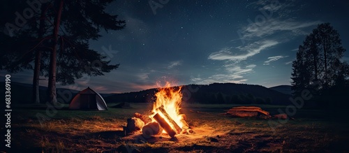 Summer night campfire replaced by camp base under the stars