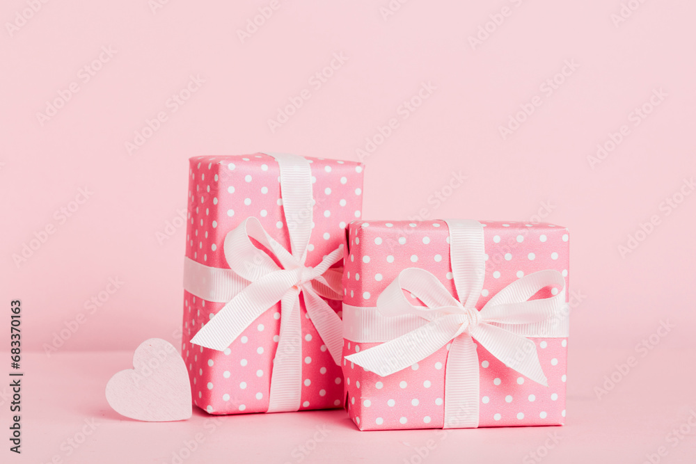 gift box with red bow and red heart on colored background. Perspective view. Flat lay gift box with red bow and red heart on colored background. Perspective view. Flat lay