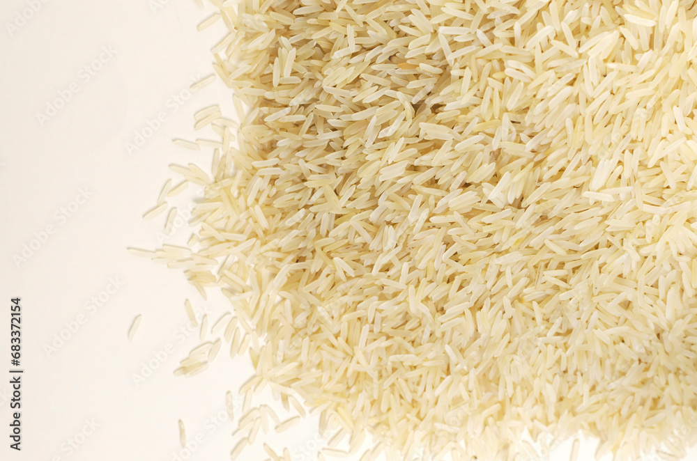 A heap of raw basmati rice. Concept of Water-Conserving Products. Saving water. When growing rice, 10-20% of water is consumed. Horizontal orientation. Top view. Copy space. A heap of raw basmati rice. Concept of Water-Conserving Products. Saving water. When growing rice, 10-20% of water is consumed. Horizontal orientation. Top view. Copy space.