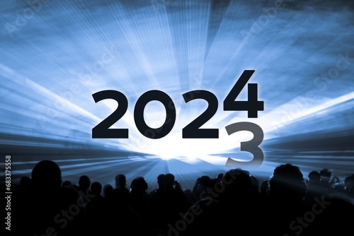Turn of the year 2023 2024 blue laser show party. Luxury entertainment with people crowd audience silhouettes at new year celebration. Premium nightlife event at holidays season time