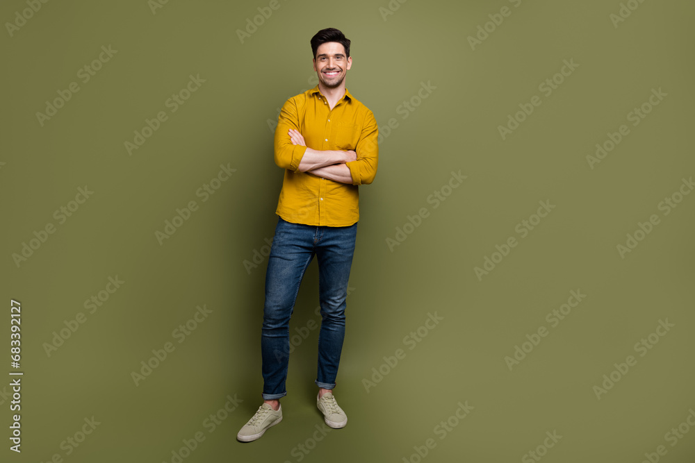 Full length photo of cheerful successful man dressed trendy collection outfit standing empty space isolated on khaki color background Full length photo of cheerful successful man dressed trendy collection outfit standing empty space isolated on khaki color background
