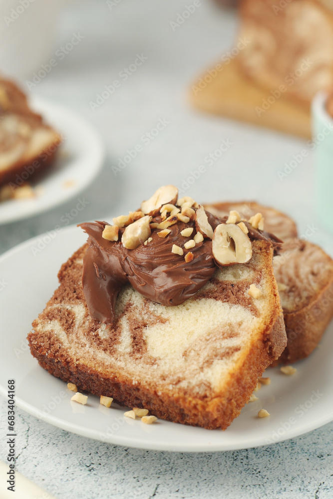 A piece of marble biscuit with chocolate cream and nuts A piece of marble biscuit with chocolate cream and nuts