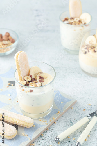 Milk mousse dessert with nuts in glasses	