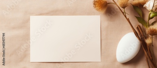 Minimal table top view with blank card mockup on beige linen tablecloth Space for text Wedding invitation or menu with Scandinavian style