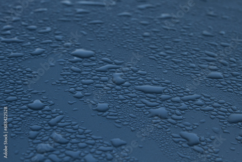 Raindrops on the surface in dark blue shades
