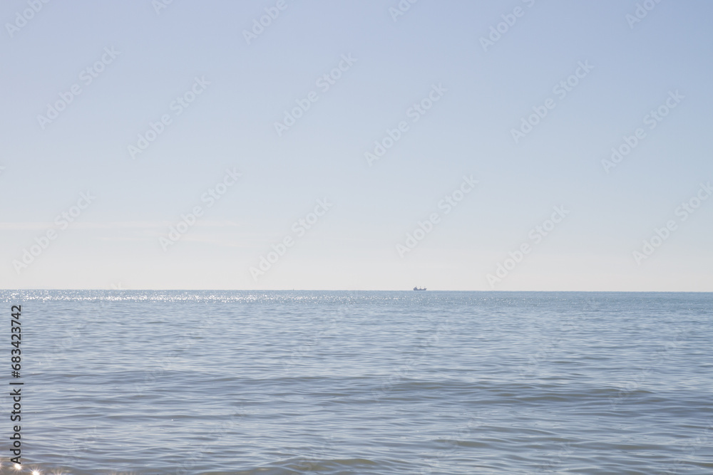 Ship sailing into the distance in a seascape with natural colors