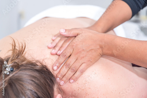 person receiving a back massage, body massages, decontracturizing in a spa, back massage