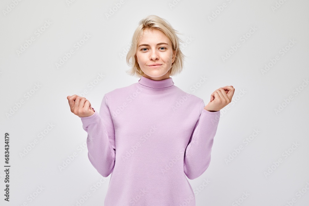 Young blond woman in casual holding something in hand, demonstrating empty space for product or text isolated on white studio background. Young blond woman in casual holding something in hand, demonstrating empty space for product or text isolated on white studio background.