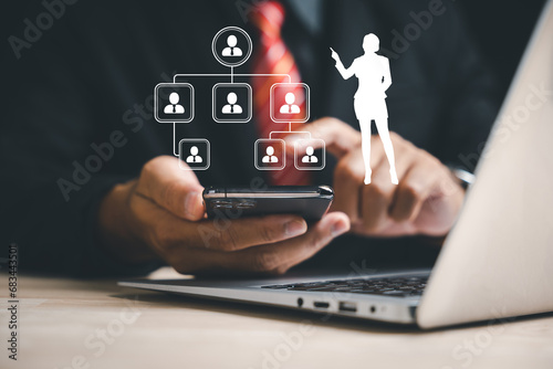 Efficient Candidate Selection: A businessman, using a smartphone with advanced technology, carefully picks the best employee. Integrating digital solutions into HR management and recruitment.