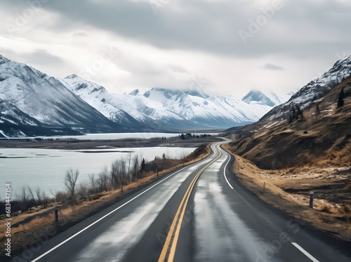 a narrow roadway going towards mountains covered with snow in in winters © DailyLifeImages