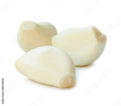 Peeled garlic cloves in stack isolated on white background with clipping path and shadow in png file format.
