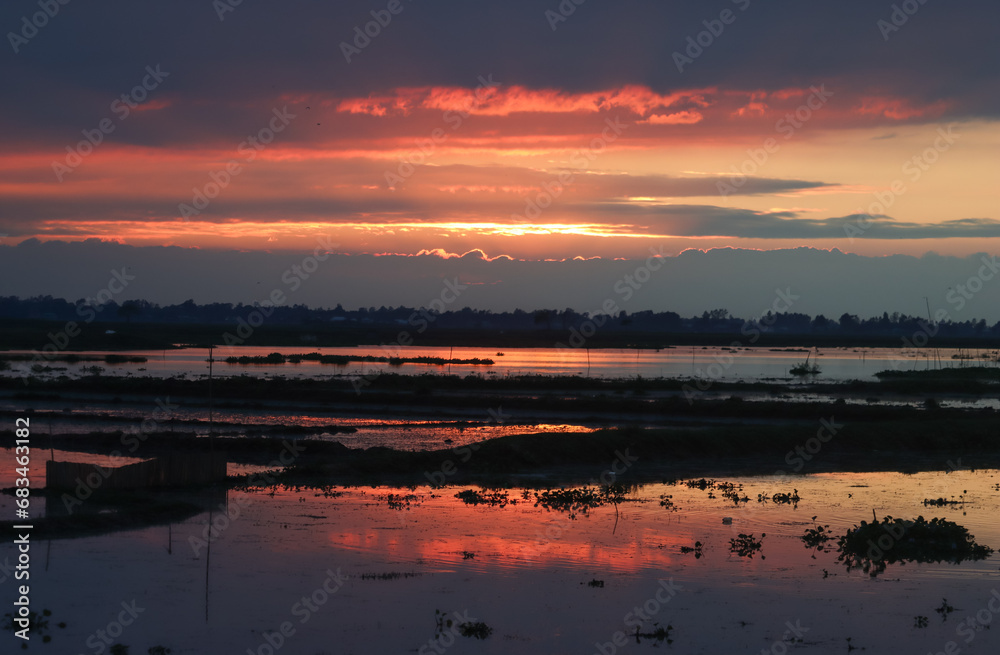 sunset sky over the lake during autumn season in the rural Bangladesh 