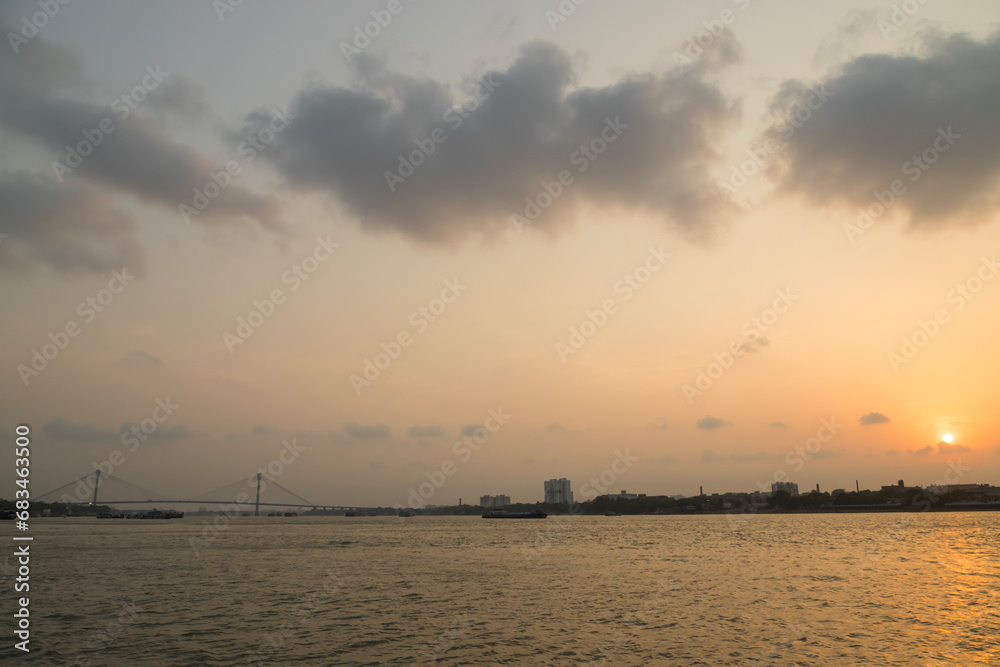 Vidyasagar Setu bridge with fishing boat on river Ganges at sunset at Kolkata India
