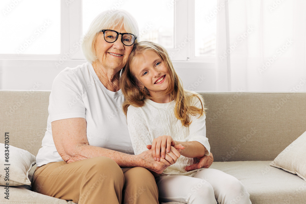 Woman family girl home grandmother old child sofa couch happy elderly love granddaughter Woman family girl home grandmother old child sofa couch happy elderly love granddaughter