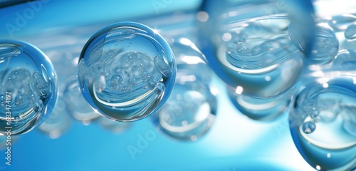 Transparent water bubbles on a blue background, ideal for purity concepts and clean water campaigns. #683474197