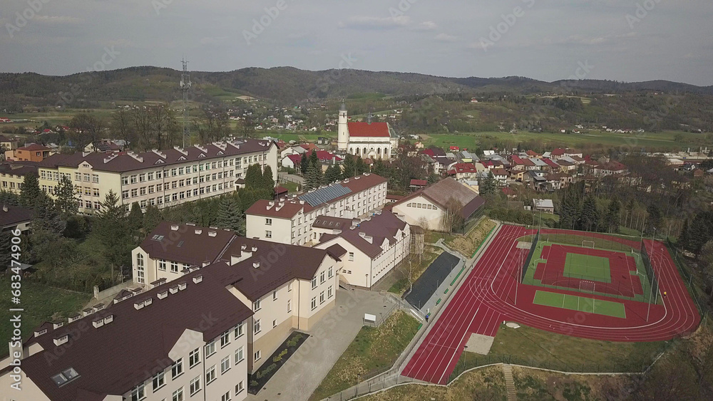 Bich, Poland - 9 9 2018: Photo of the old part of a small town from a bird's eye view. Aerial photography from a drone or quadcopter of a school sports stadium. Promote tourist destinations in Europe.