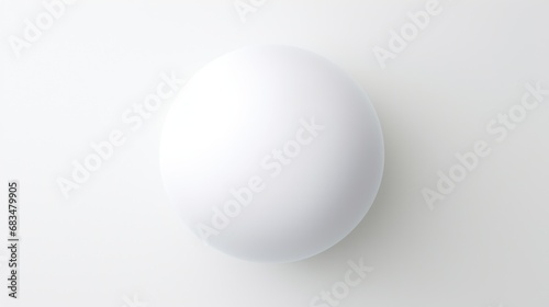  a white egg sitting on top of a white table next to a black and white clock on a white wall.