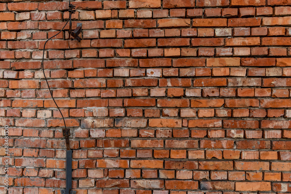 Old red brick wall damaged lightning rod collapsing brick wall