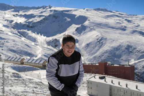 young latin guy with cold,playing in the snow,ski resort sierra nevada,granada,granada,spain