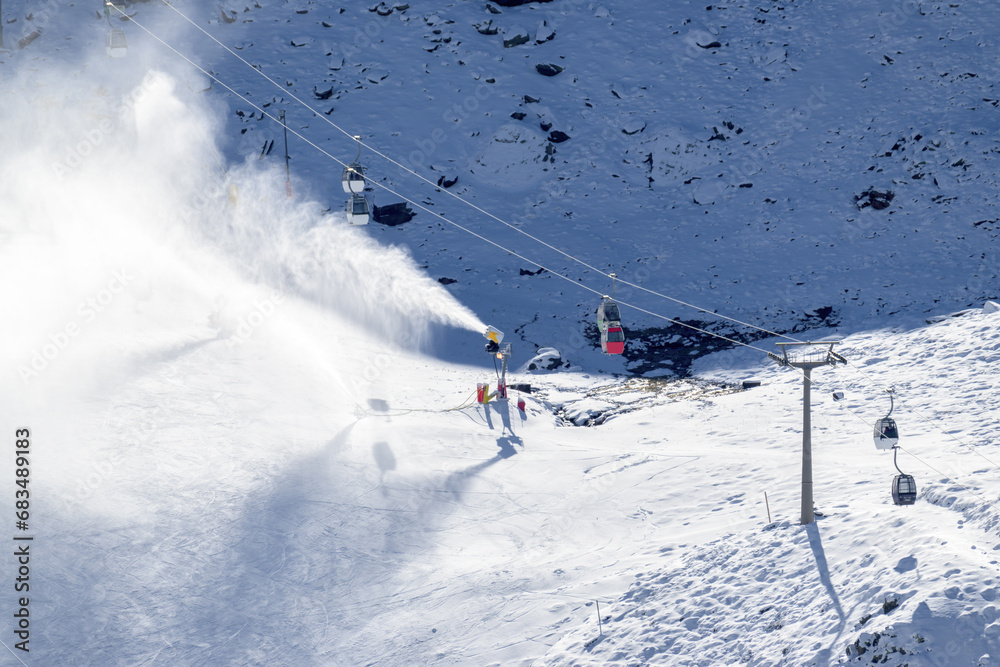 snow cannons, spreading snow on the slopes next to the cable cars in sierra nevada ski resort