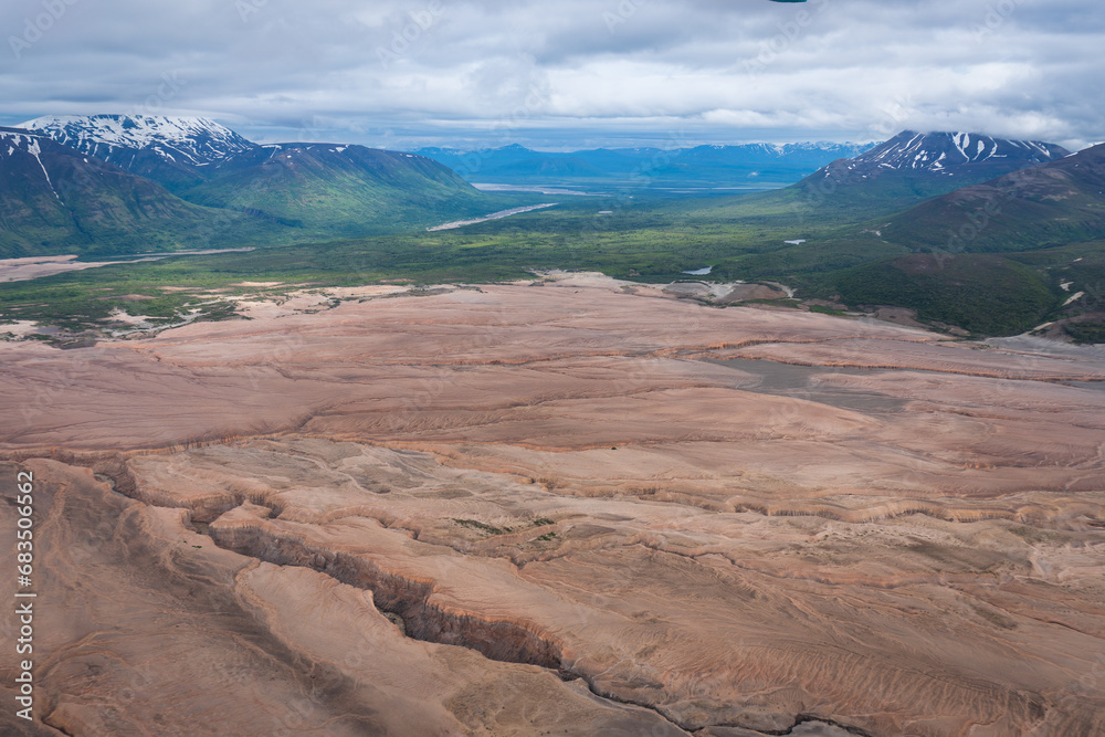 The Valley of Ten Thousand Smokes in Katmai National Park and Preserve in Alaska is filled with ash flow from Novarupta eruption in 1912. River eroding volcanic ash flow. Aerial view.