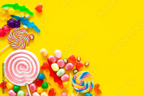 Colorful lollipops and different gummies jelly and candies, top view